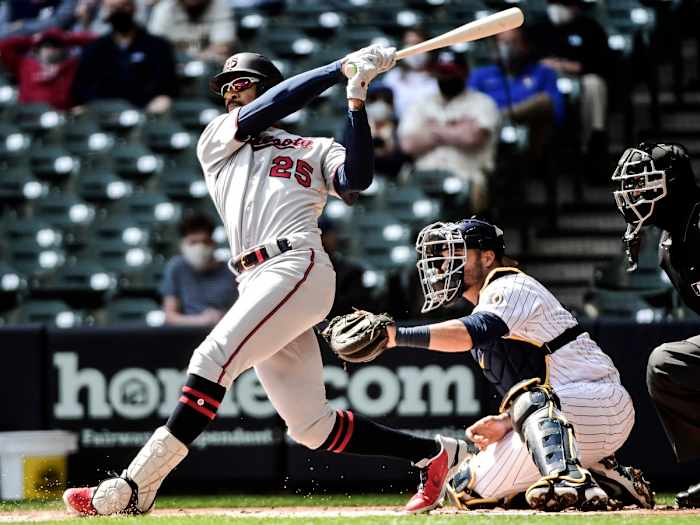 Apr 4, 2021; Milwaukee, Wisconsin, USA;  Minnesota Twins center fielder Byron Buxton (25) hits a double in the first inning as Milwaukee Brewers catcher Manny Pina (9) watches at American Family Field.